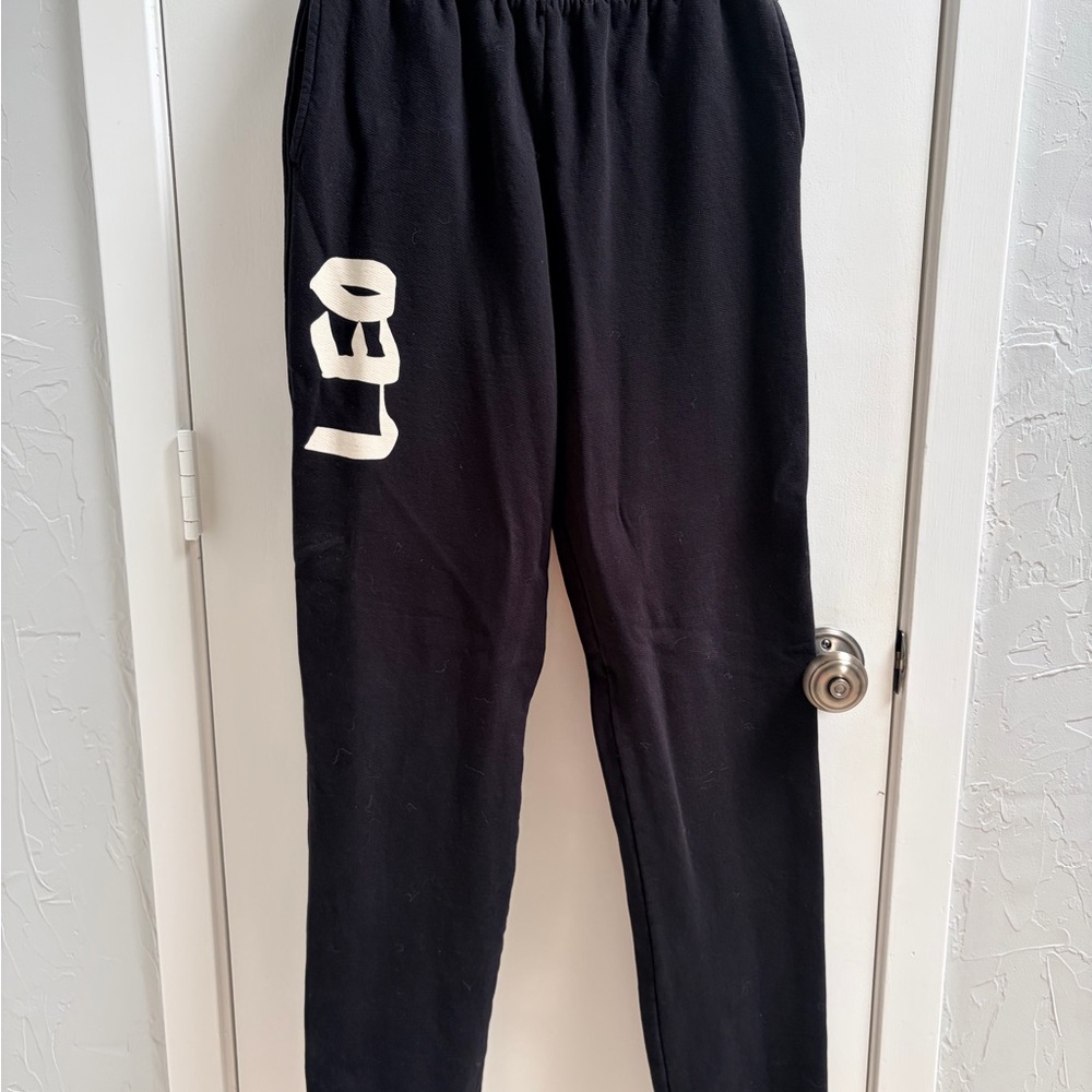 Good American Black Track Joggers with White 'LEO' Graphic